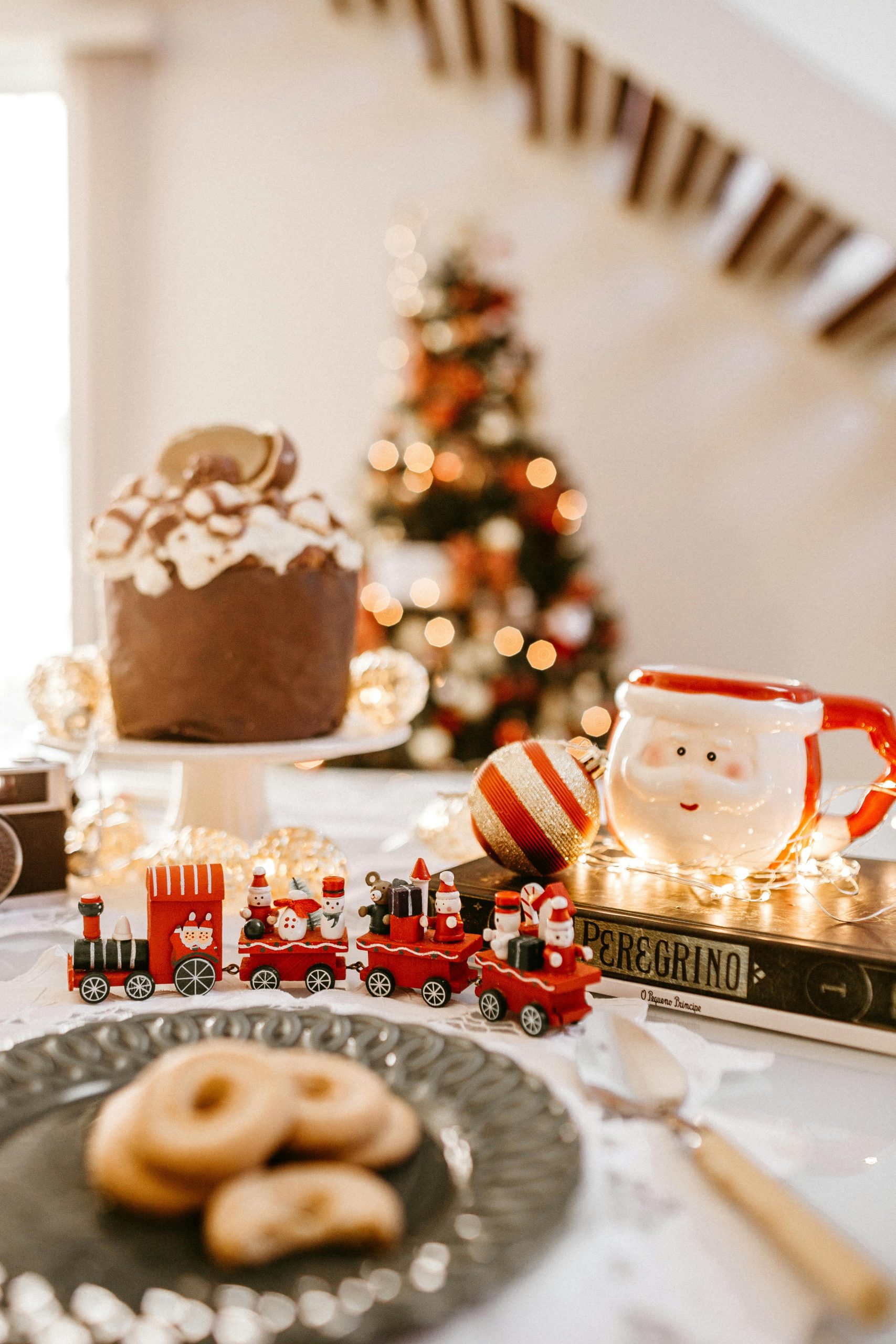 Cozy indoor Christmas scene with Santa mug, treats, and decorations.